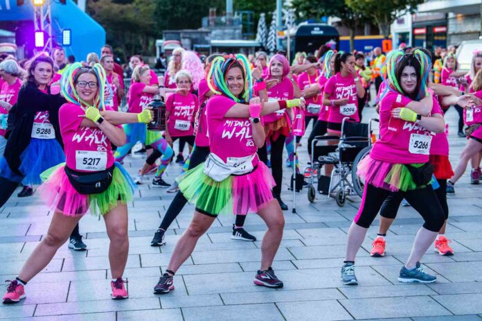 Midnight Walk, the much-loved charity event, is returning to Plymouth in 2021. Ladies warming up for the Midnight Walk for St Luke's