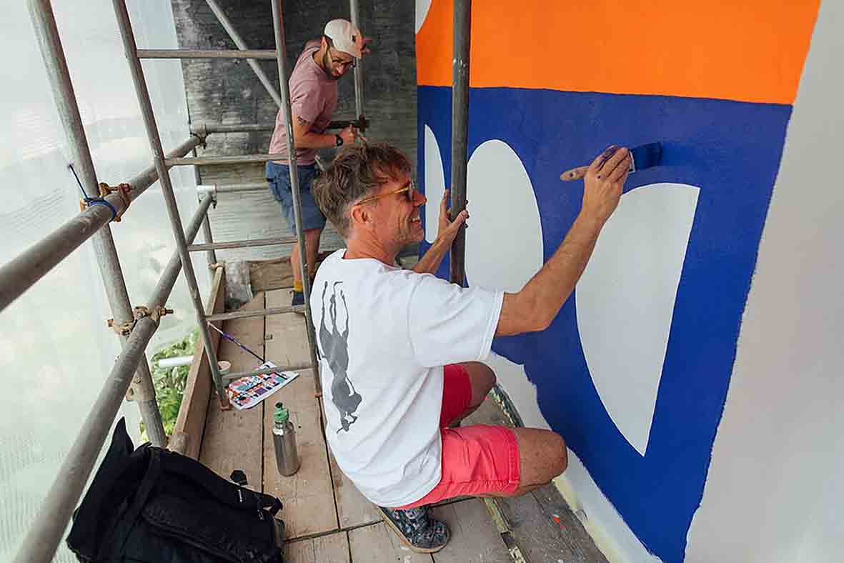 Artists Stephen Smith (foreground) and Will Luz at work on the mural Photo: Dom Moore