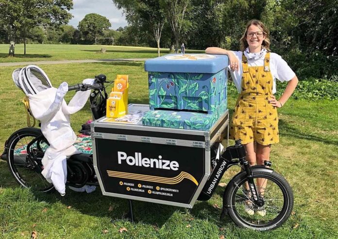 Brittany Clarke, marketing and communications assistant at Pollenize, with their E-cargo bike and decorated beehive in Central Park. Brittany Clarke, marketing and communications assistant at Pollenize, with their E-cargo bike and decorated beehive in Central Park.