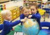 Foundation stage children look for lakes and oceans on the globe as they begin the new Ocean curriculum at Leigham Primary School