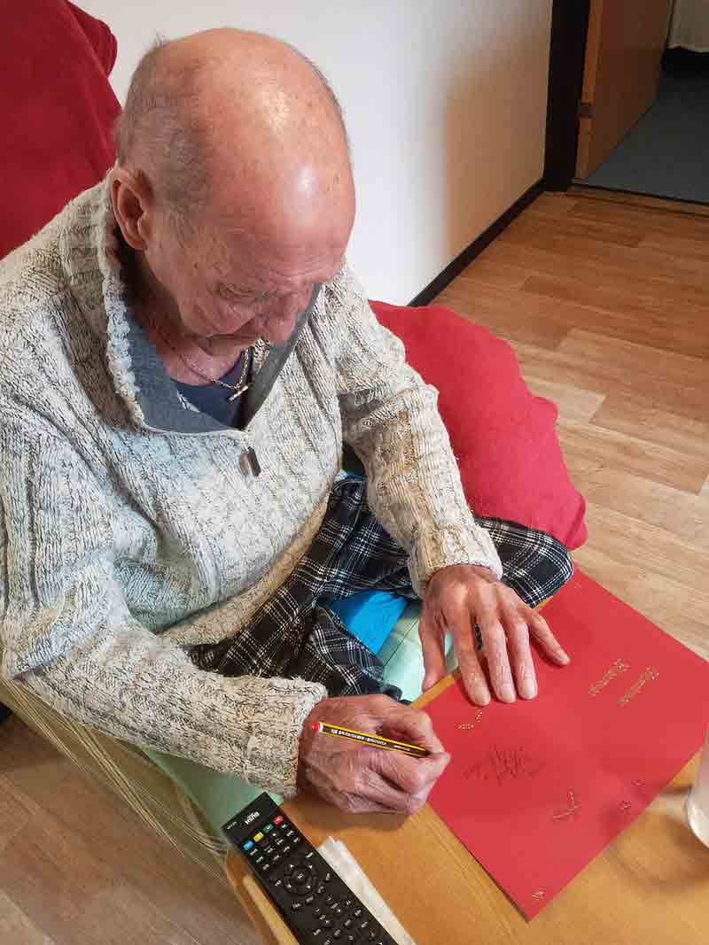 Resident Trevor Greenaway writing cards