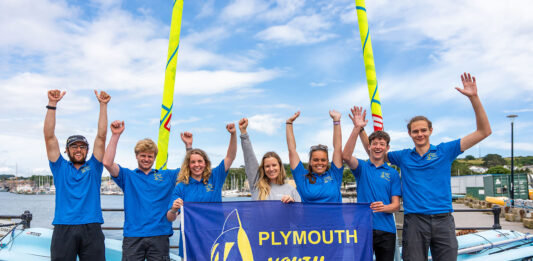 Hannah Mills (centre) pictured with members of Plymouth Youth Sailing Club