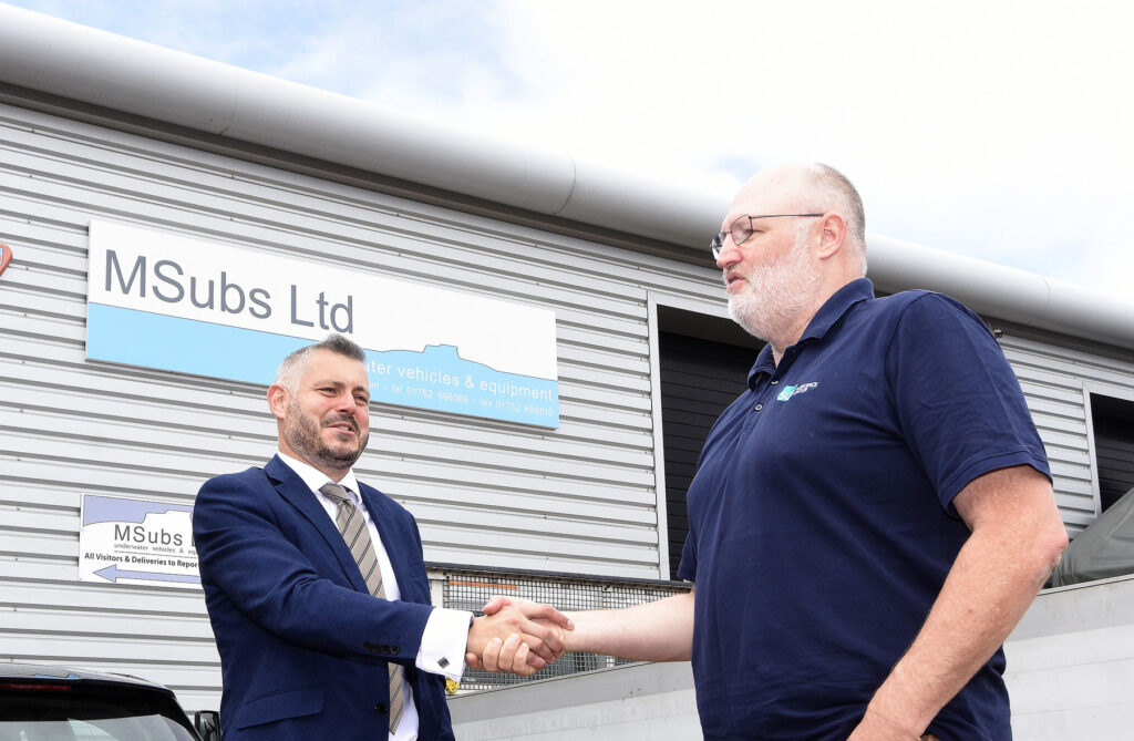 Council leader Richard Bingley shaking hands with Brett Phaneuf director of MSubs
