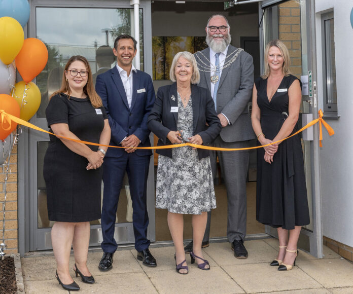 Dame Mary Perkins cutting the ribbon at the opening Dame Mary Perkins cutting the ribbon at the eye clinic opening