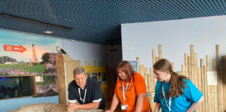 Age UK Plymouth works in partnership with Plymstock School to pioneer volunteer programme for young people Former Plymstock School volunteer Caitlin (right) joined staff and clients from the Dementia Day Centre at the National Marine Aquarium’s Dementia Friendly Session in September