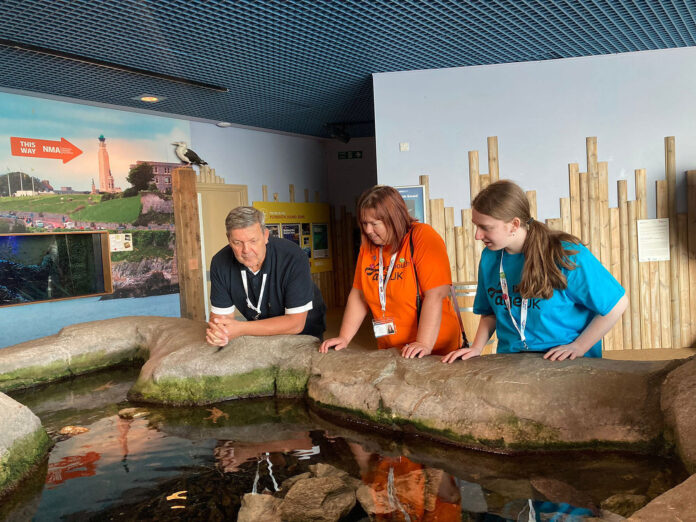 Former Plymstock School volunteer Caitlin (right) joined staff and clients from the Dementia Day Centre at the National Marine Aquarium’s Dementia Friendly Session in September Former Plymstock School volunteer Caitlin (right) joined staff and clients from the Dementia Day Centre at the National Marine Aquarium’s Dementia Friendly Session in September