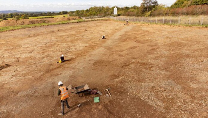 Ancient-remains-Sherford-Credit_-AC-Archaeology.-Image_-working-view-looking-north-west The Roman road discovered at Sherford viewed towards Plympton in the north west Inset: some of the flint remains