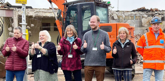 Councillors, local residents and one of the contractors celebrate the demolition