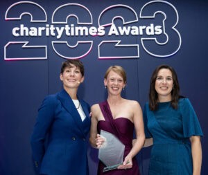 Liz Harding (centre) pictured with the ‘Rising Leader of the Year’ award at the 2023 Charity Times Awards.