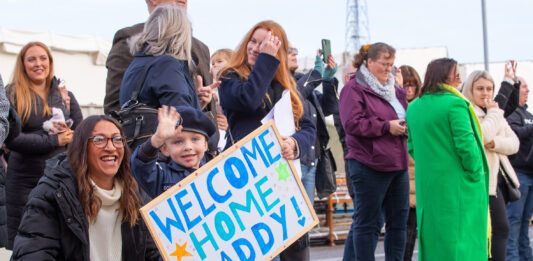Pictured: Families waving at their loved ones, as ships company of HMS Portland arrives back home in Plymouth. The Devonport based Type 23 frigate HMS Portland, has arrive back at her base port in Plymouth having returned from a busy period patrolling in UK water and across the North Atlantic. The Ship was welcomed by friends and families on the Jetty after sailing the final few miles from Plymouth Sound up the River Tamar. Her deployment in the North Atlantic also included a stop off in Halifax, Nova Scotia on Canada’s Eastern Seaboard, where she attended the first International Sea Week held at the newly refurbished Halifax Naval Base. During the visit the Ship’s Rugby team played a game against a North Atlantic select. HMS Portland also joined the HMS Queen Elizabeth Carrier Strike group and operated with other NATO partners.