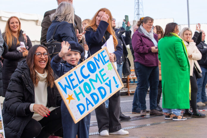 HMS PORTLAND RETURNS HOME Pictured: Families waving at their loved ones, as ships company of HMS Portland arrives back home in Plymouth. The Devonport based Type 23 frigate HMS Portland, has arrive back at her base port in Plymouth having returned from a busy period patrolling in UK water and across the North Atlantic. The Ship was welcomed by friends and families on the Jetty after sailing the final few miles from Plymouth Sound up the River Tamar. Her deployment in the North Atlantic also included a stop off in Halifax, Nova Scotia on Canada’s Eastern Seaboard, where she attended the first International Sea Week held at the newly refurbished Halifax Naval Base. During the visit the Ship’s Rugby team played a game against a North Atlantic select. HMS Portland also joined the HMS Queen Elizabeth Carrier Strike group and operated with other NATO partners.