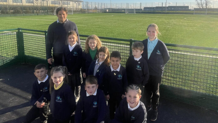 3G pitch at MAP Johnny Mercer MP pictured in front of the 3G pitch with youngsters at Marine Academy Plymouth