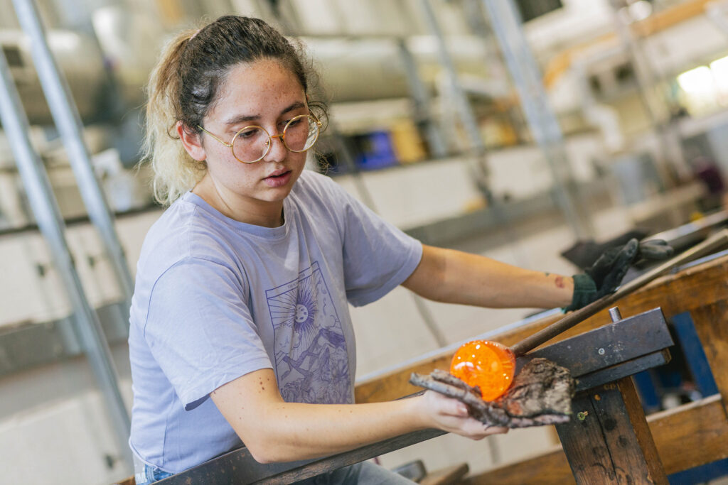 Glassmaker Zeynep Korun pictured in the glass blowing studio at Arts University Plymouth
