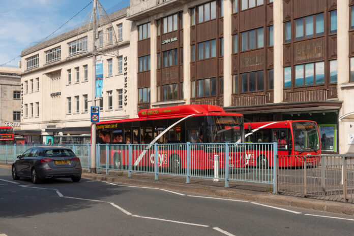 Plymouth, Devon, England, UK. 2022. Red buses on Royal Parade in the city centre of Plymouth, England, UK